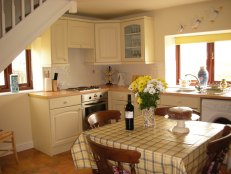Welcome flowers, wine and cake in the kitchen at Butterton Moor Cottage in the Peak District National Park